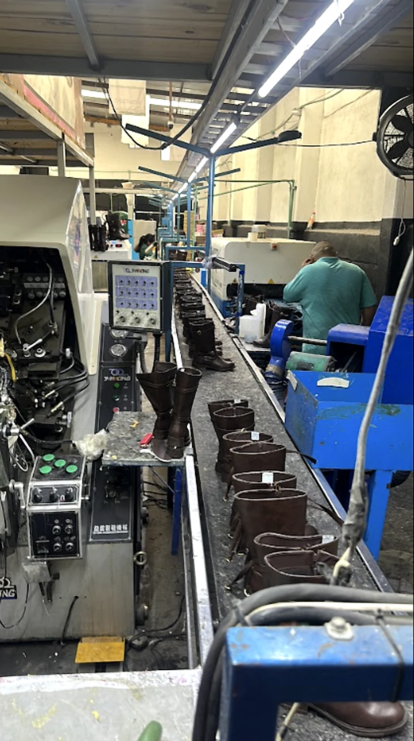 Boot production line in the workshop, with machinery and boots lined up on the conveyor